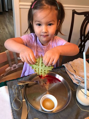 Daughter Enjoying Waffles with Kale Food Coloring